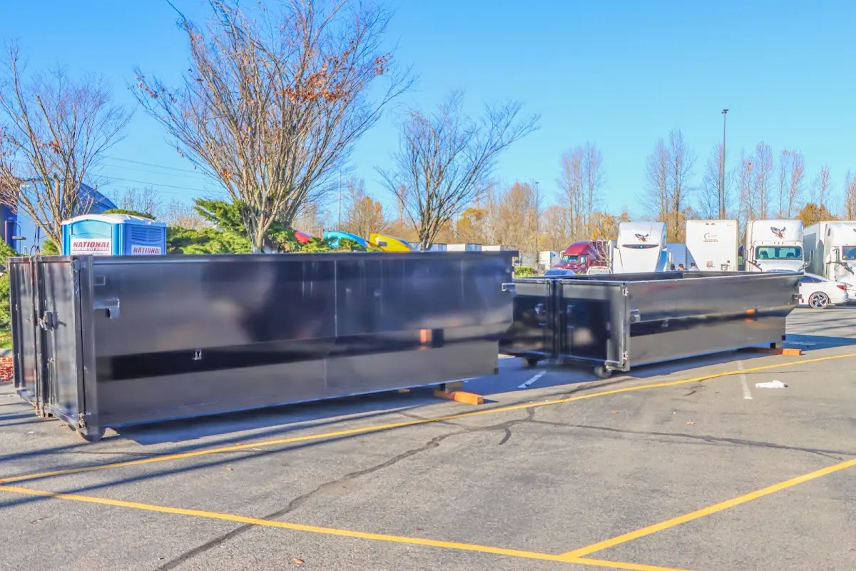 Professional dumpster rental service with roll-off container on residential driveway in Tucson